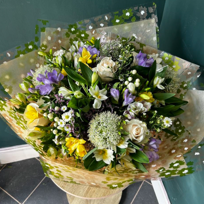 Spring Harmony - A delightful mix of spring flowers in soft pastels, including lilies and roses. Ideal for brightening someone's day or celebrating the beauty of the season.