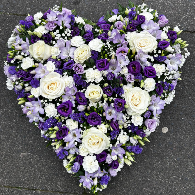 Purple Heart Tribute - A heart-shaped arrangement of purple and white flowers, including roses, carnations, and lisianthus. Ideal for funerals and memorials to express deep sympathy and love.