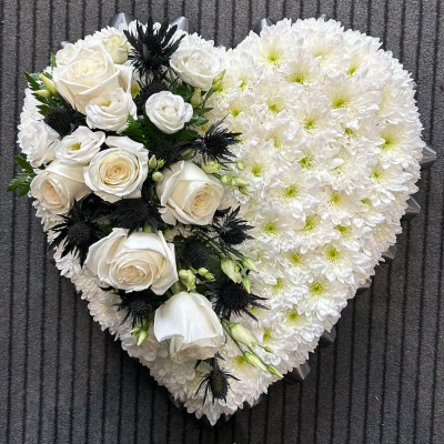 Classic White Heart - A pristine white heart-shaped arrangement with roses and thistles. Perfect for expressing pure and heartfelt condolences.