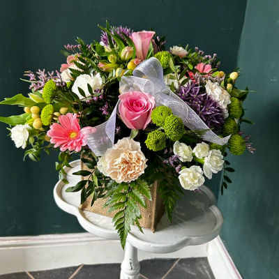 Charming Pink Bag - A charming bag with pink roses, green chrysanthemums, and white carnations. Perfect for any occasion to show you care.