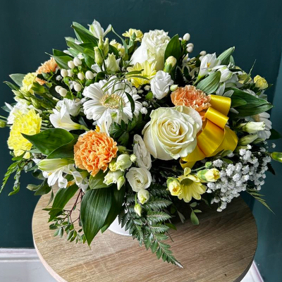 Sunshine Celebration Hatbox - A bright and cheerful arrangement with yellow, orange, and white blooms. Perfect for celebrating joyful occasions and bringing sunshine into any space.