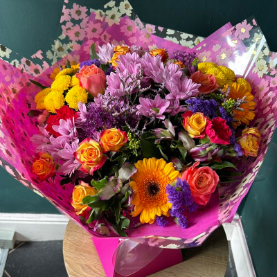 Colourful Joy - A lively arrangement of mixed bright flowers. Perfect for celebrations and bringing a burst of colour to any room.