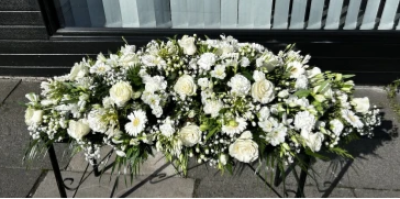 Cherished Love - A casket oasis made in shades of white. 

Using seasonal flowers of the florists choice this casket oasis is available in 4 sizes 3ft, 4ft, 5ft and 6ft.
Shaped to sit atop the casket this arrangement is made to be viewed from all angels making it a stunning choice for a loved one.

A bespoke option is available for any flower requests please contact us at 0191 4784321 to discuss availability and prices