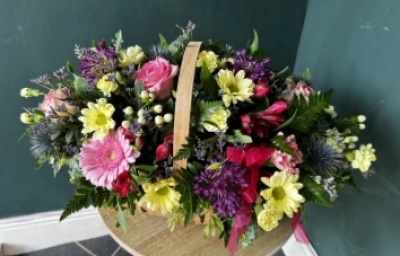 Summer Breeze - Summer Breeze is a traditional basket arrangement.
Using summer colours in season flowers this arrangement is sure to brighten someone’s day. 

Made in a traditional trug container this arrangement is oval in shape make it perfect for a hearth or long coffee table.