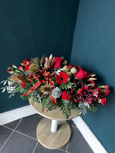 Yuletide Cheer - Yuletide Cheer is new for Christmas 2024

Made in an oval basket this long and low arrangement is the prefect gift for the festive season.

Traditional colours and style this formal arrangement is full of festive cheer, made using seasonal foliage and flowers.

Flowers featured are the medium