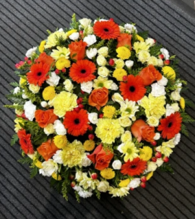 Warm Glow - This bright posy is a beautiful funeral tribute.