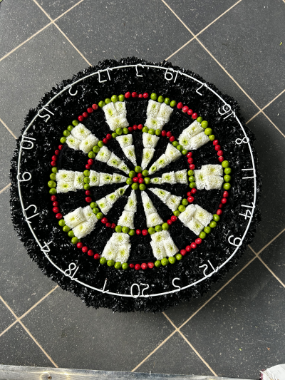 Dartboard - The perfect tribute for a darts fan!

Made to size this dartboard is made using chrysanthemum hand sprayed to black and hypericum berry in green and red, finished off using an actual number ring form a dartboard. 

A minimum of 5 days notice is required