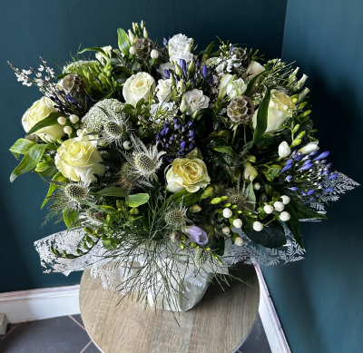 The Luna - The Luna is a beautiful vase arrangement.
Made in a palette of calm colours of whites, creams, purples and lilacs. This vase arrangement is made using seasonal flowers in a meadow style, featuring delicate flowers and stunning white roses.